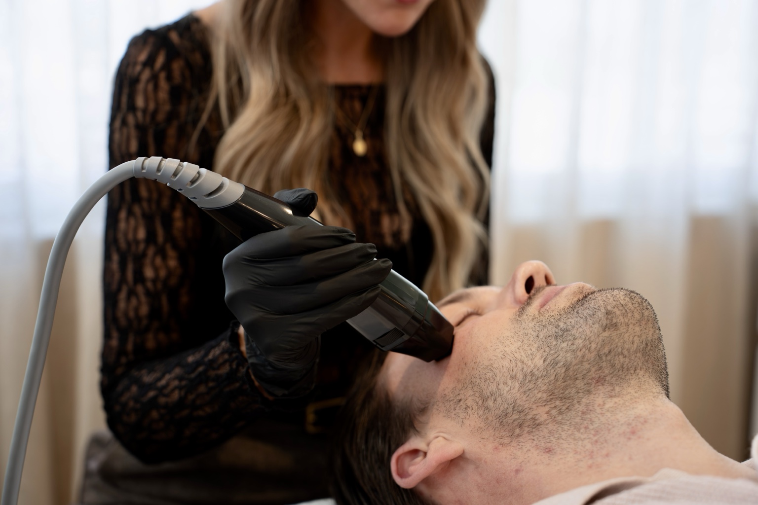 A man receiving a facial treatment at Imani